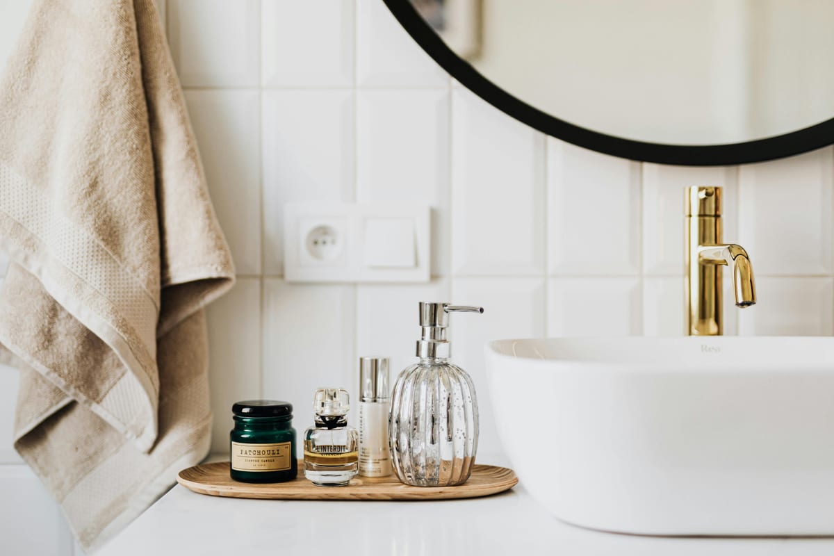 A stylish bathroom sink with skincare products and accessories for modern living.