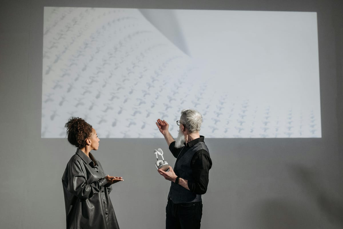 Business professionals discussing innovative product with a digital projection.